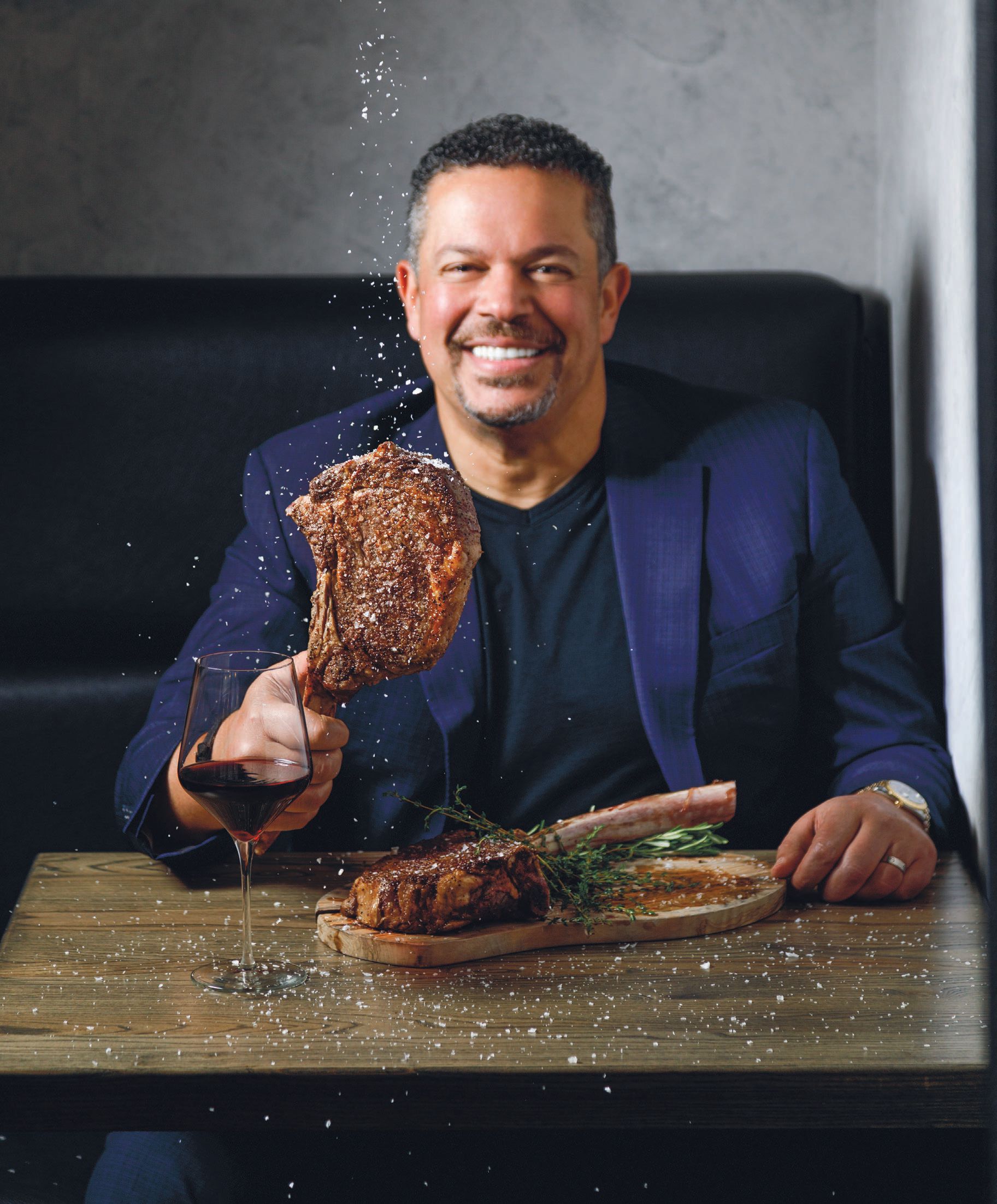 Ayman Kamel in the newest 5Church location in Buckhead with the fan-favorite tomahawk steak PHOTO BY PATRICK HEAGNEY