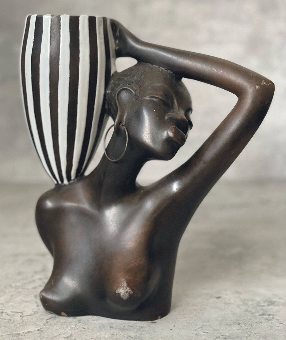Handcrafted in Austria, this ceramic sculpture depicts the female form holding a glazed vase. PHOTO COURTESY OF SUSTAINABLE HOME GOODS