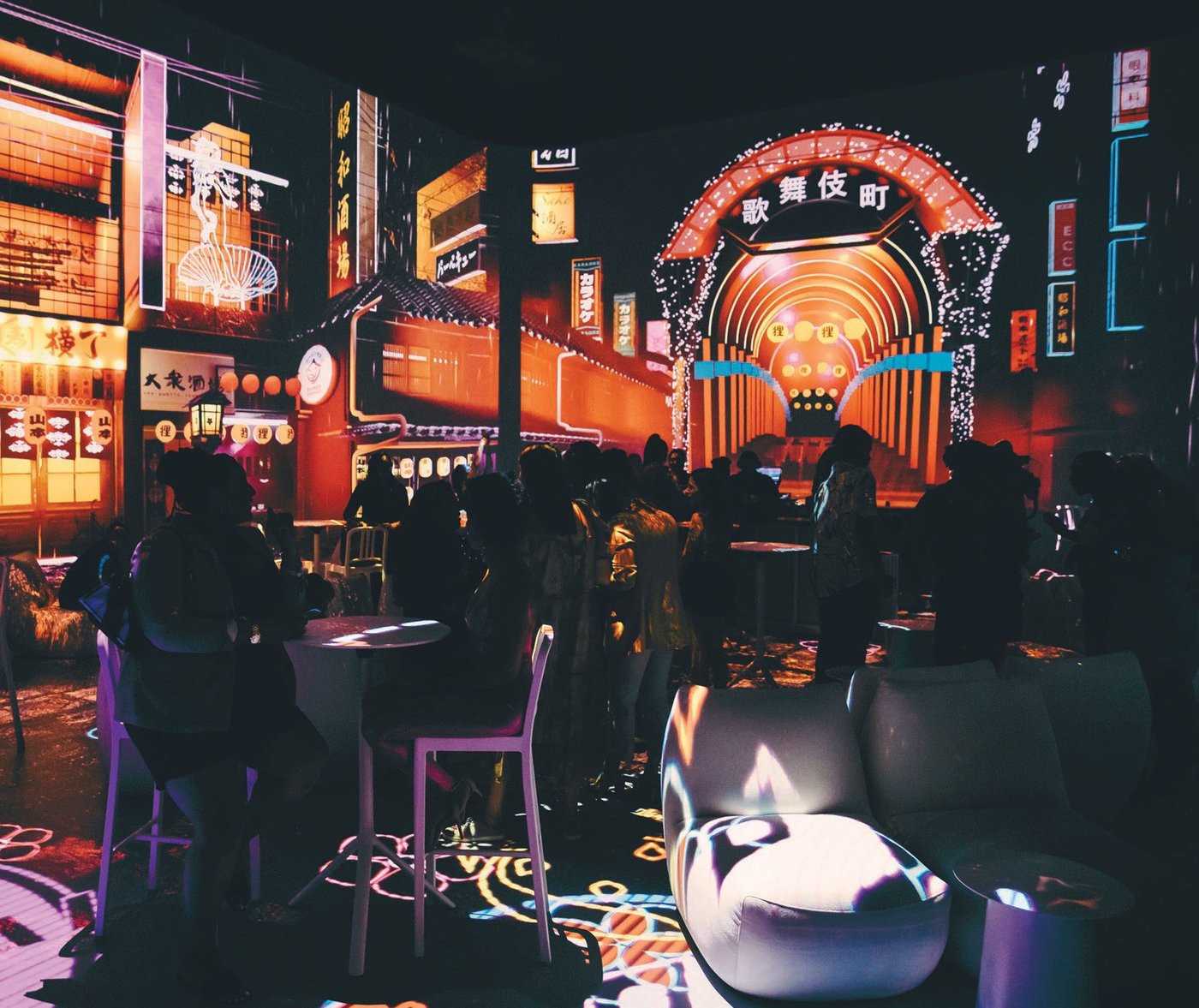 Shibuya Night Market transports diners to a glowing neon night market in Tokyo with fluorescent lights, lanterns and holograms that animate the Japanese architecture. PHOTO BY JORDAN VIISION FOR ROCKWELL GROUP