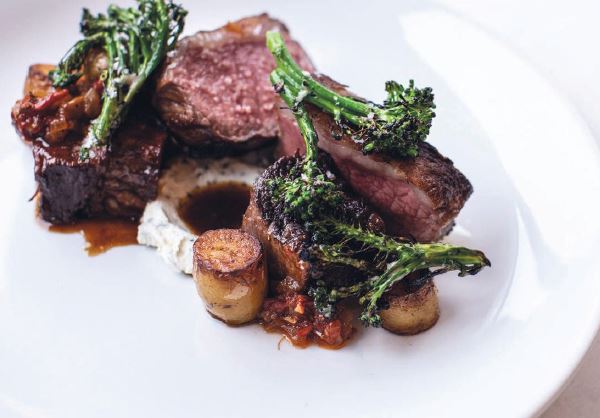 Prime New York strip with braised sweet peppers, chevre, roasted potatoes and haricots verts PHOTO BY HEIDI HARRIS/COURTESY OF THE CHASTAIN